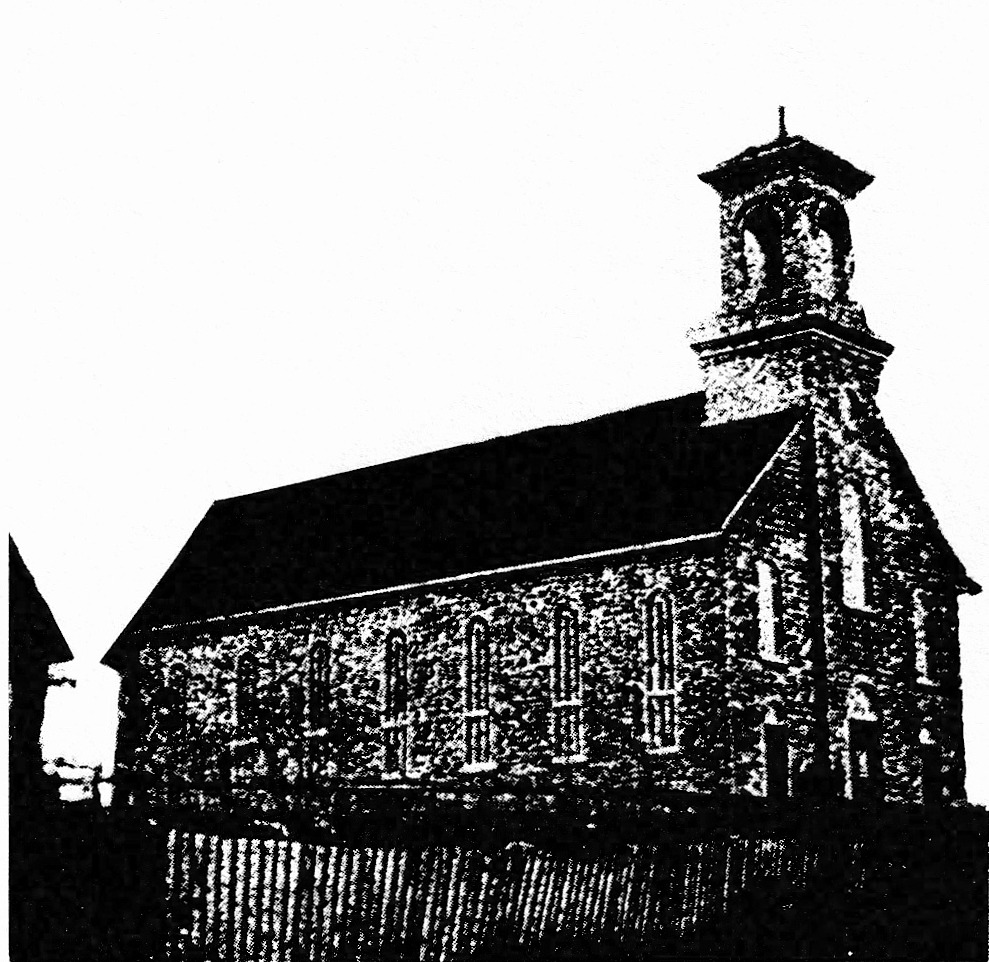 Black and white photograph of a large stone church with a tall steeple