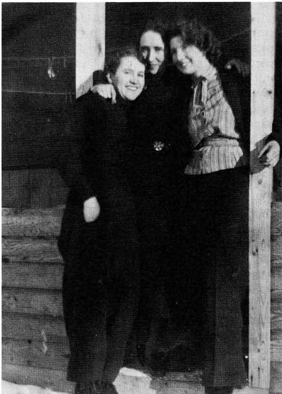 Black and white photograph of three women standing outdoors