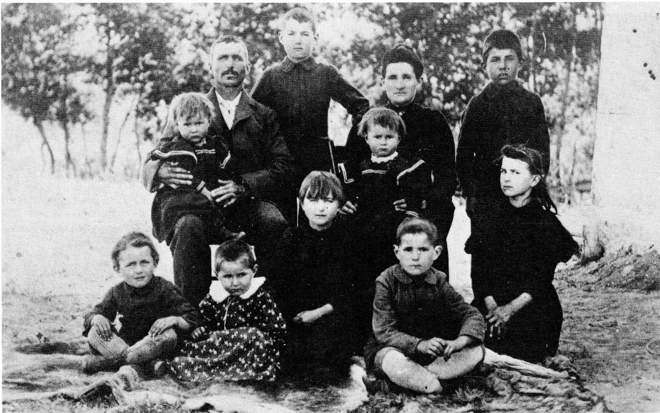 Black and white photograph of the Moise L'Heureux family outdoors, circa 1895-96.