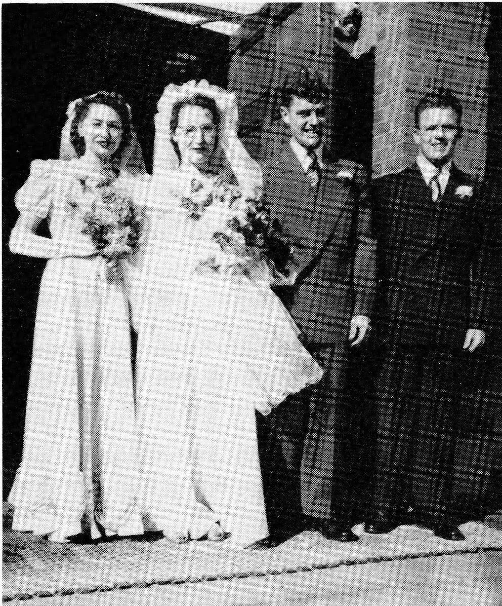 Black and white photograph of a wedding party with bride, groom, bridesmaid, and groomsman