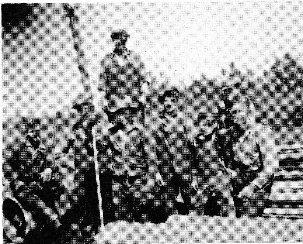 Black and white photograph of seven men at a sawmill in the 1930s.
